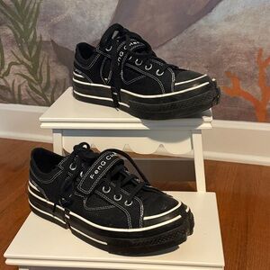 Converse x Feng Chen Wang black deconstructed shoes.
